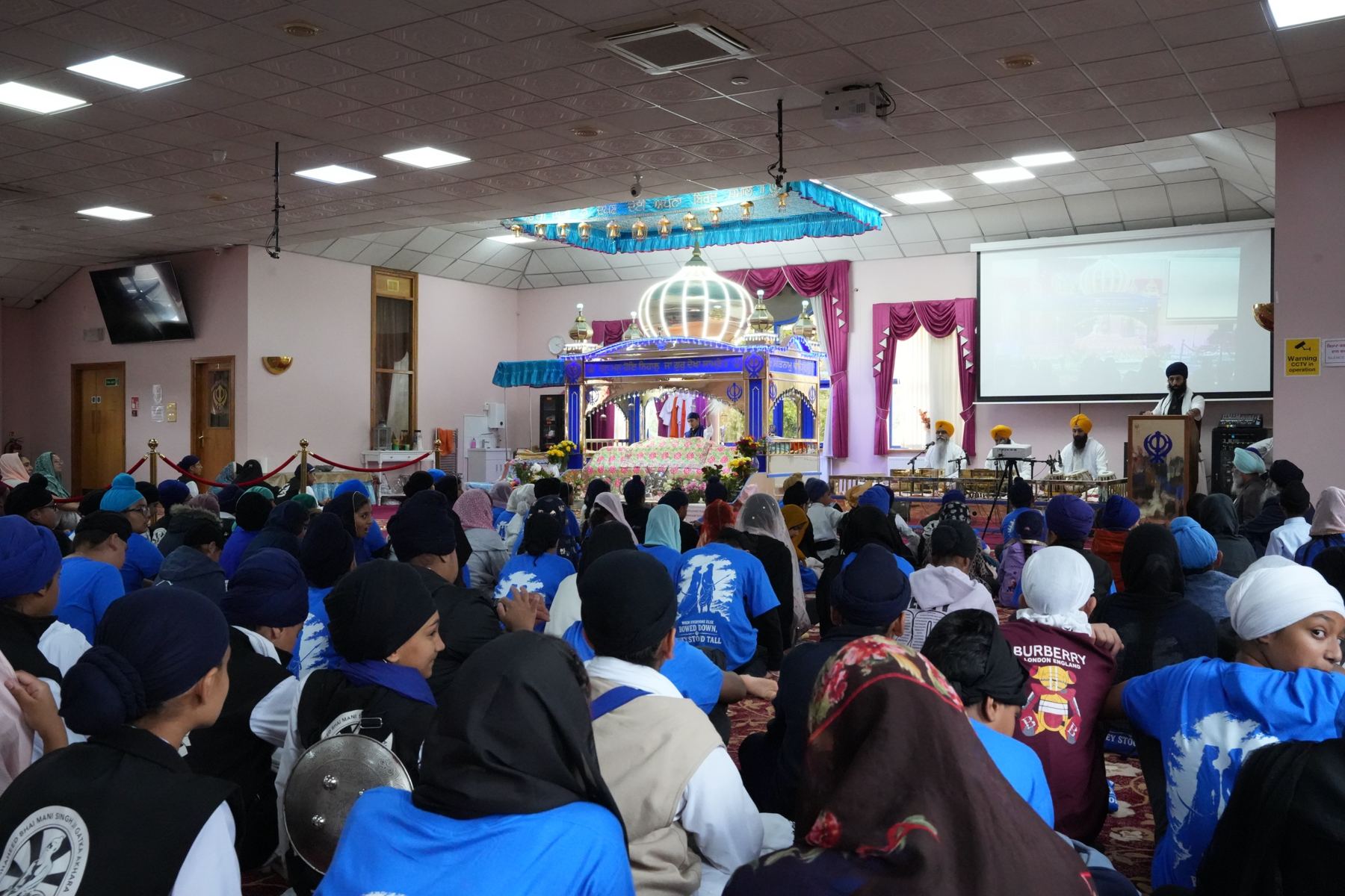 The sangat seated in the darbar hall during a programme