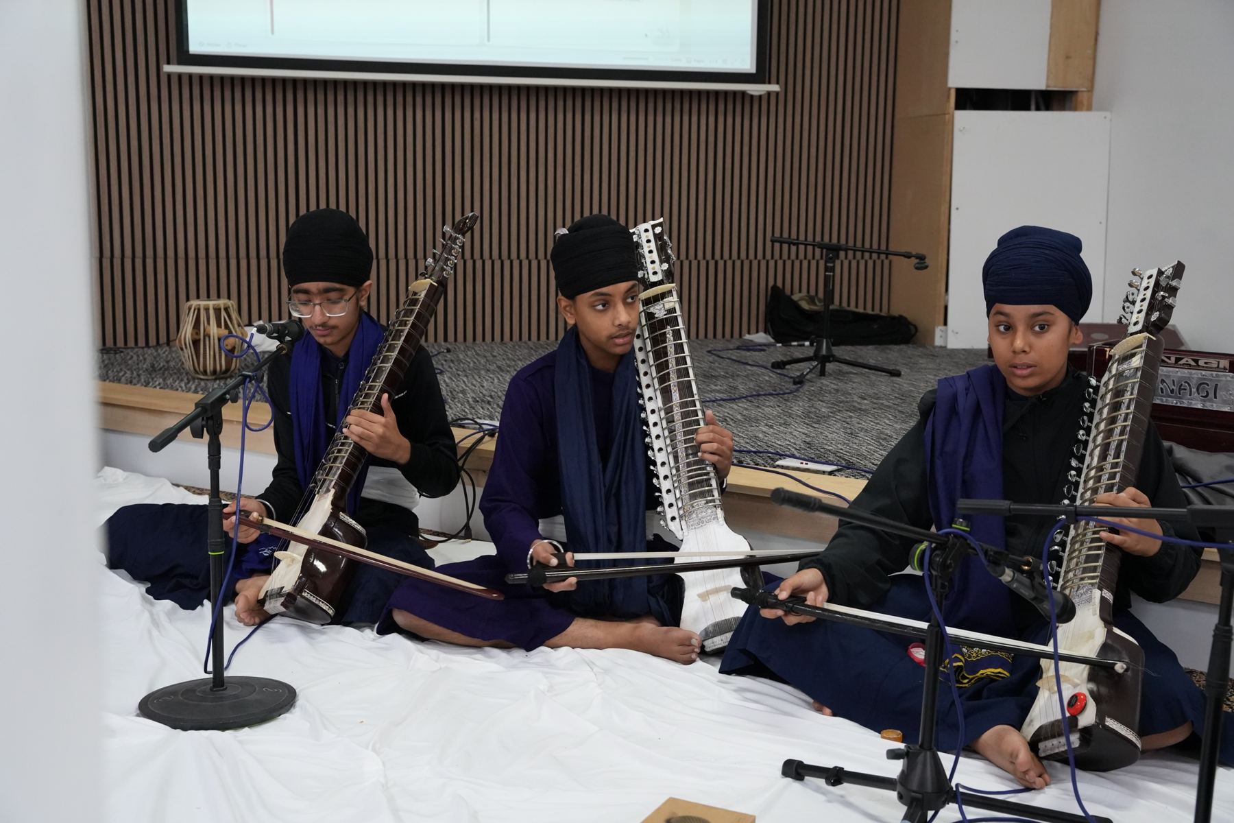 Three students playing the taus